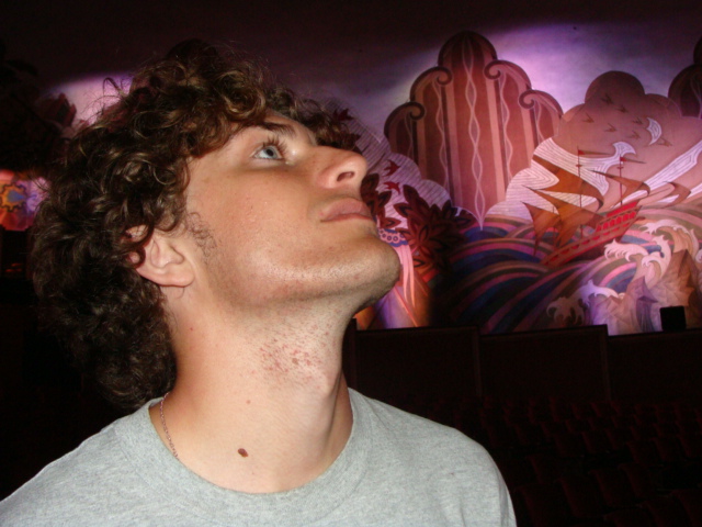 Liam Pauzer in front of a colorful mural